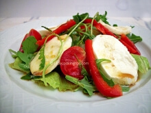 Arugula (rocket), iceberg lettuce and mozzarella salad with orange juice sauce 