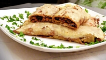 Baked crepes with ground meat and melted cheese