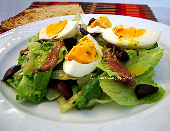 Lettuce salad with eggs, kalamata olives and anchovies Lettuce salad with eggs, kalamata olives and anchovies